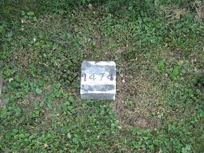An unknown soldier's grave marker at Antietam National Cemetery — small square stones with only a number, no name
